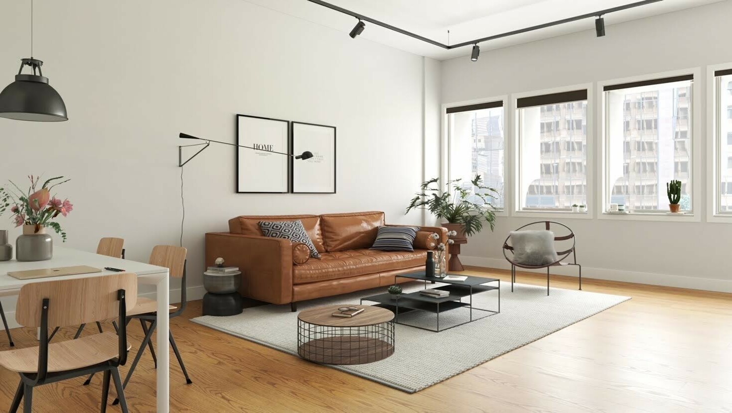 Apartment lounge setting looking out big windows at city scape with buildings.