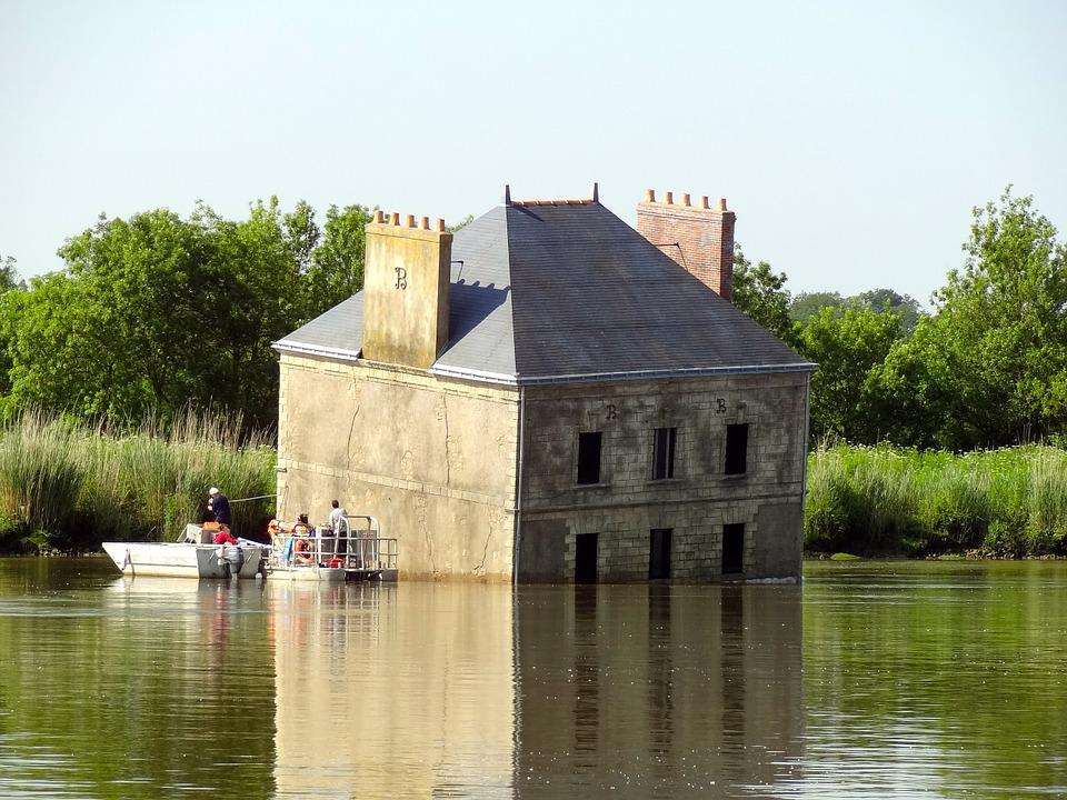 House sinking in river