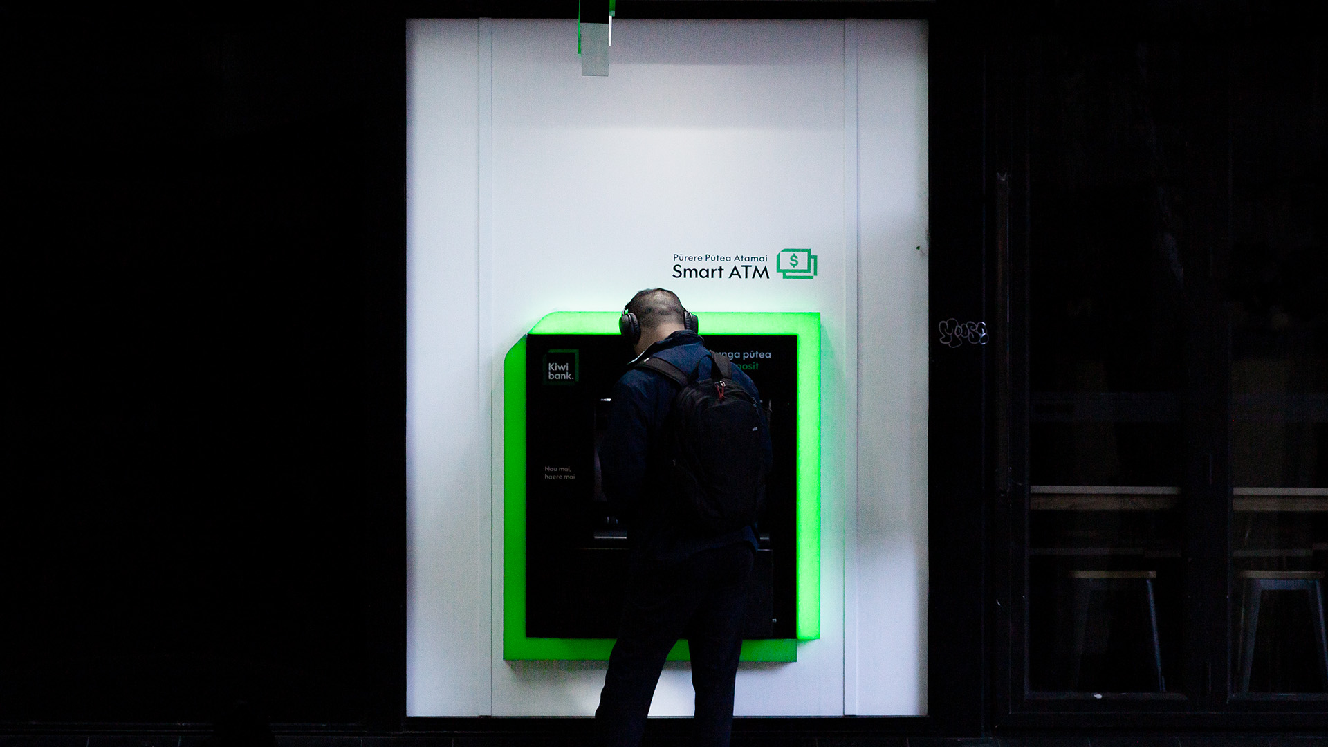 Man takes money from a Kiwibank ATM machine