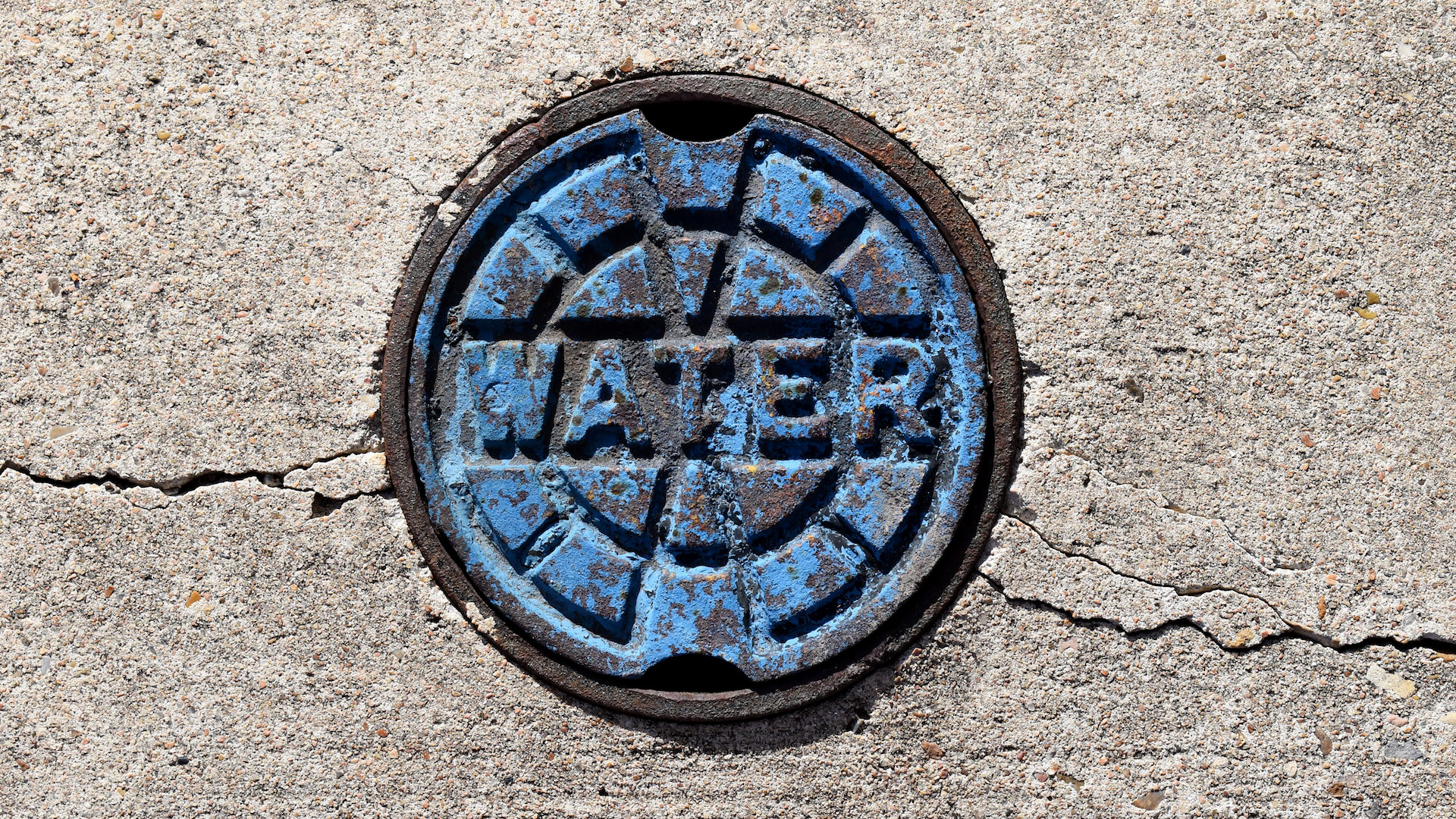 A drain cover labelled water 