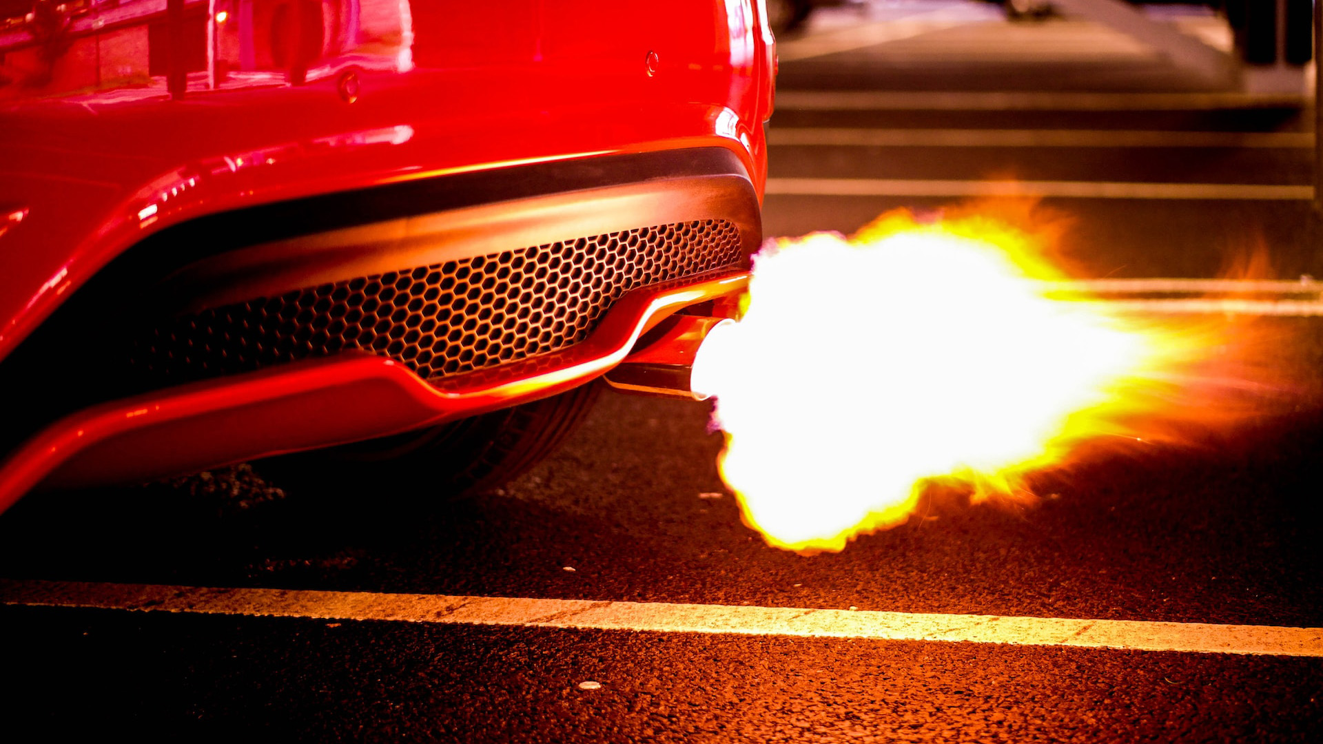 A car back-fires out of its exhaust 