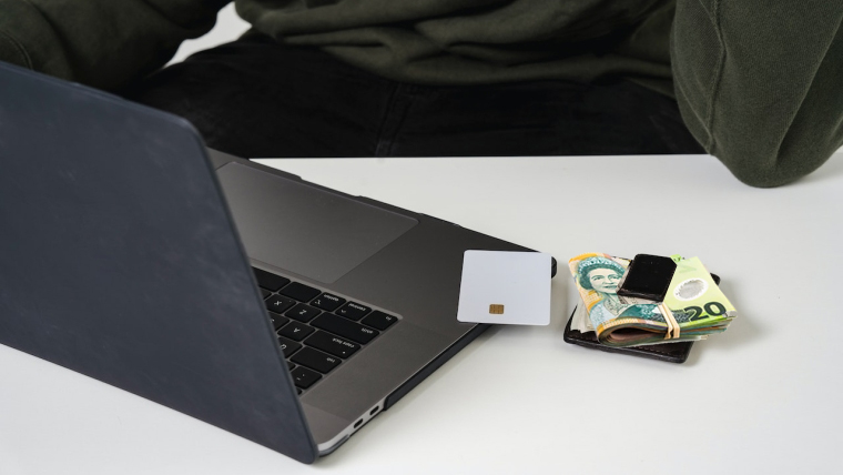 laptop, bank card, and cash