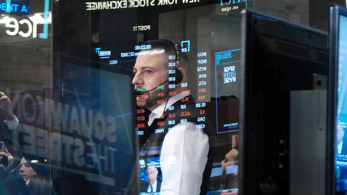 Trader reflected in screens