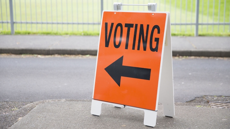 A black and orange voting sign in New Zealand.