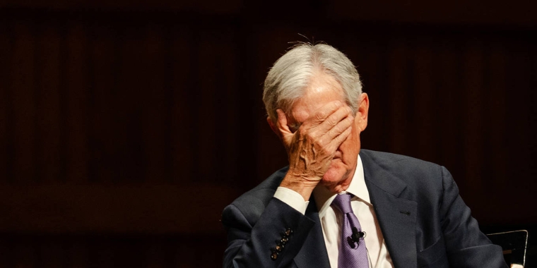 Jerome Powell covering his face