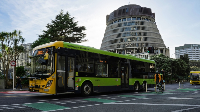 A Metlink bus passes the Beehive in Wellington.