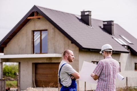 Builders in front of house