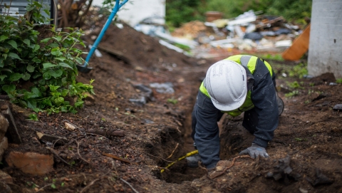 Tradesperson working in trench.