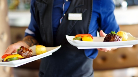 Waiter carrying tow plates