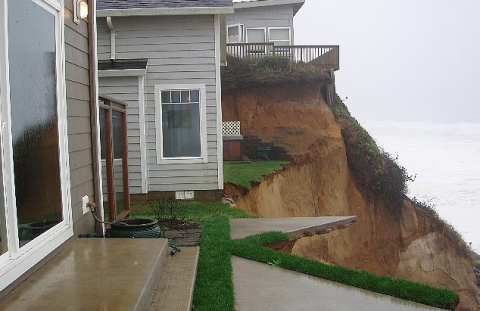 House at edge of eroding cliff