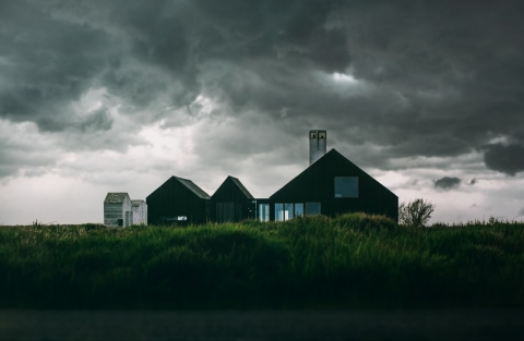 Storm clouds gathering over a house
