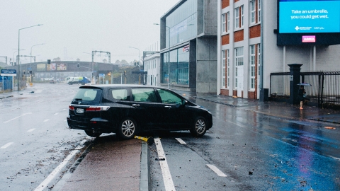 A mini-van abandoned in the middle of the road during Auckland flooding