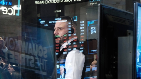 Trader reflected in screens