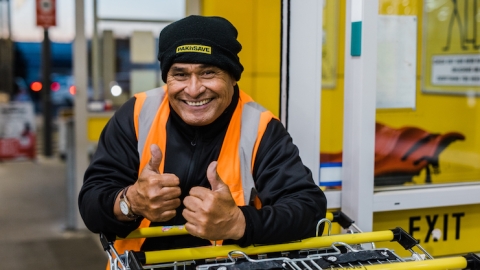 Pak 'n Save worker leaning on trolley.