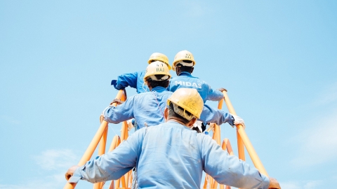 Workers climb a ladder