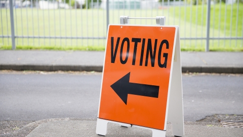 A sign pointing toward an Electoral Commission polling booth