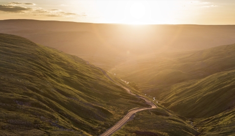 sunrise over long road