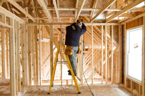 Builder inside house under construction