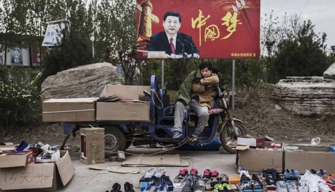 Chinese street vendor under Xi sign