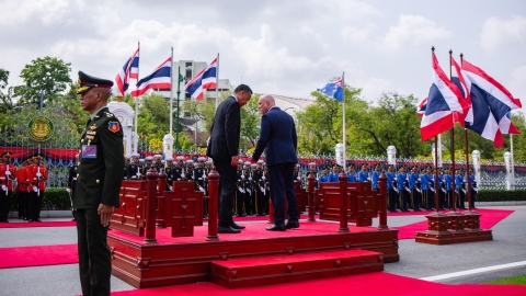 Prime Ministers Srettha Thavisin and Christopher Luxon speak while inspecting the Thai King's Guard at Government House