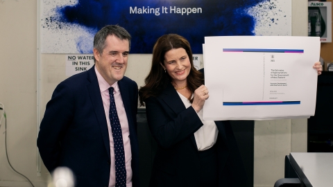 Chris Bishop and Nicola Willis hold up the cover of the Budget 2024, fresh off a printer in Petone