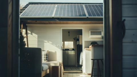 An image of a house with solar panels on the roof.
