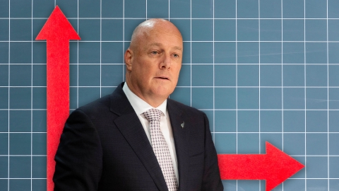 A composite image of a blue tiled backdrop with two red arrows - one pointing up and the other across, overlayed with an image of Prime Minister Christopher Luxon.