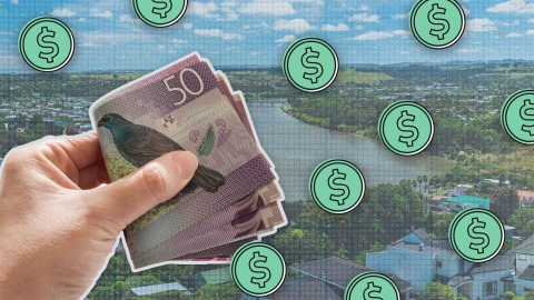 A composite image of The cityscape and the Whanganui River from Dury Hill in Whanganui overlayed with grid paper, dollar signs and a hand holding a wad of fifty dollar notes.