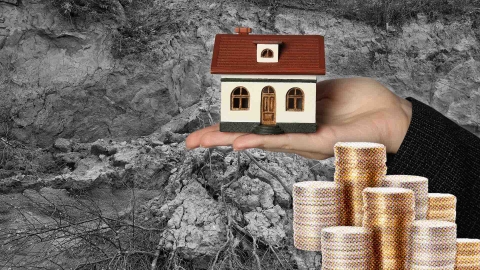 A composite image of soil erosion in the mountains overlayed with a hand holding a model home and stacks of coins.