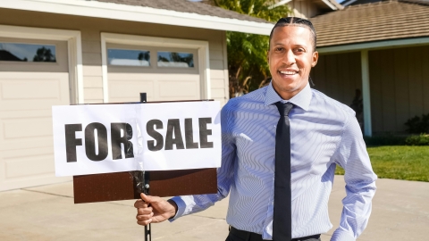 Agent with for sale sign