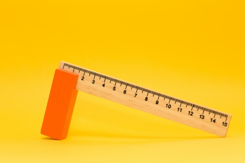 A ruler sits against a yellow background